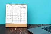 June 2023 desk calendar on top of table