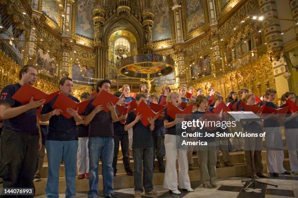 Boys & girls choir sing in the Benedictine Abbey at Montserrat, Santa Maria de Montserrat, near Barcelona, Catalonia, Spain with Black Madonna in...