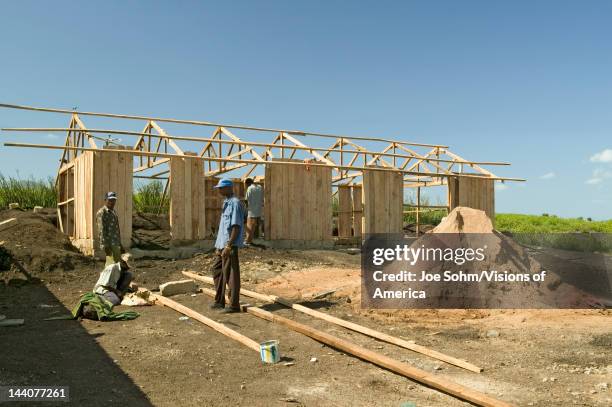 Man helps construct new houses for Pepo La Tumaini Jangwani, HIV/AIDS Community Rehabilitation Program, Orphanage & Clinic, Pepo La Tumaini Jangwani...