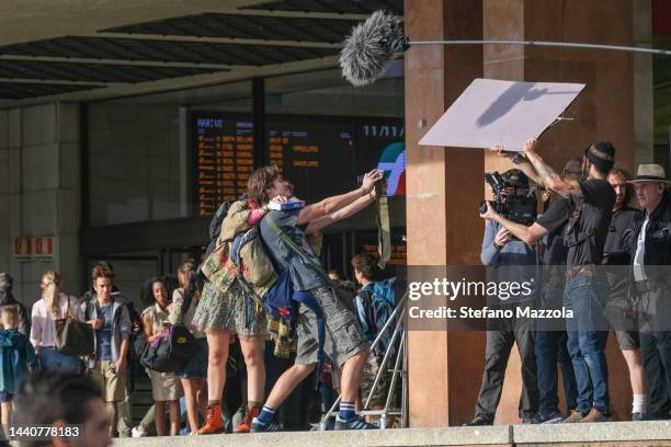 British actress Liv Hill and British actor Louis Partridge take a selfie at the Venice train station during the filming of an Apple Tv production...