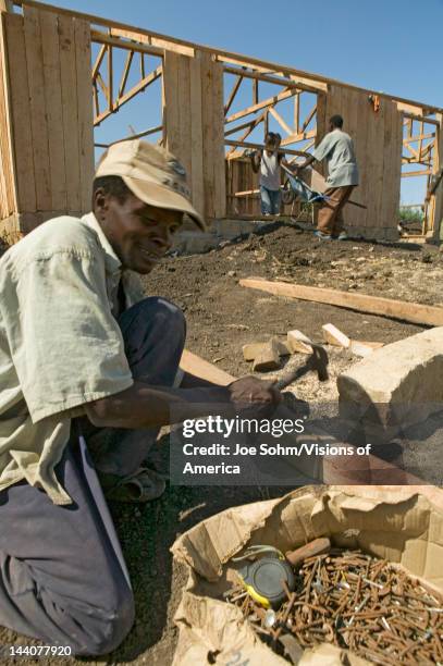 Man helps construct new houses for Pepo La Tumaini Jangwani, HIV/AIDS Community Rehabilitation Program, Orphanage & Clinic, Pepo La Tumaini Jangwani...