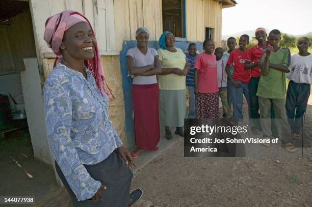 Khadija Rama, standing with a group of people, is the founder of Pepo La Tumaini Jangwani, HIV/AIDS Community Rehabilitation Program, Orphanage &...