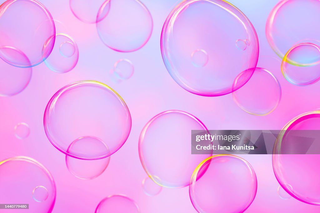 Colorful soap bubbles on pink background. Beautiful 3D pattern. Festive backdrop.