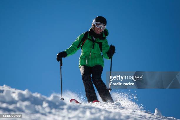 expert mature woman skier on a steep bumpy slope. - steamboat springs stock pictures, royalty-free photos & images