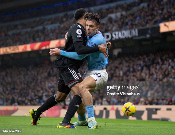 Jack Grealish of Manchester City and Kenny Tete of Fulham in action during the Premier League match between Manchester City and Fulham FC at Etihad...