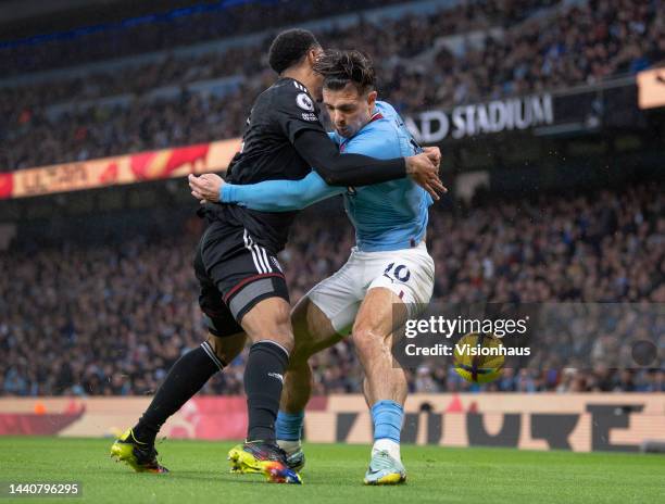 Jack Grealish of Manchester City and Kenny Tete of Fulham in action during the Premier League match between Manchester City and Fulham FC at Etihad...