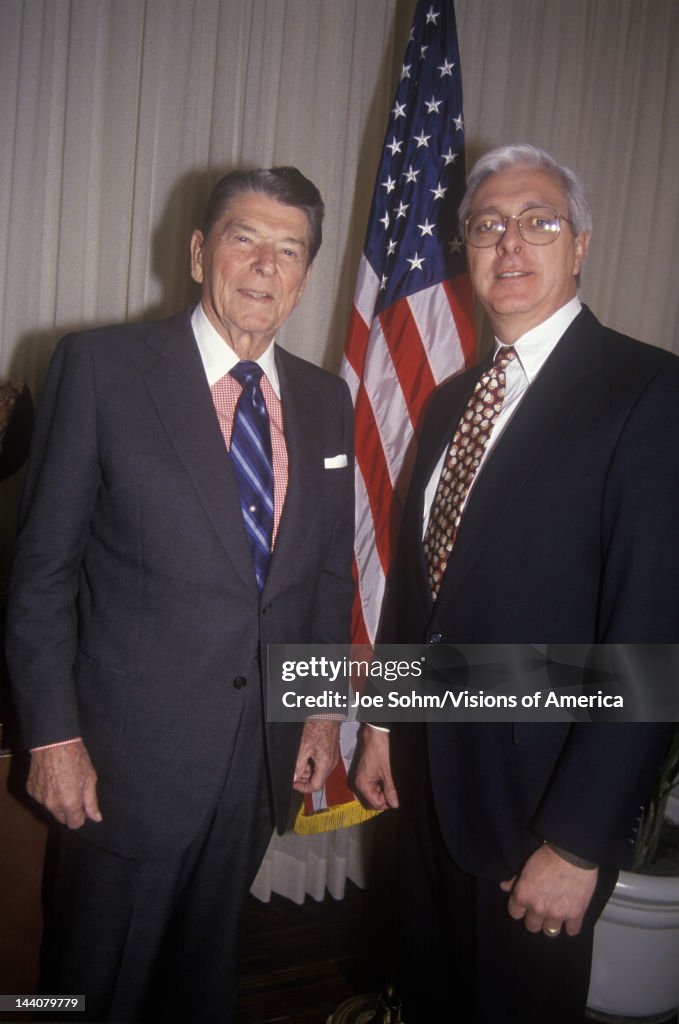 President Ronald Reagan and a politician posing