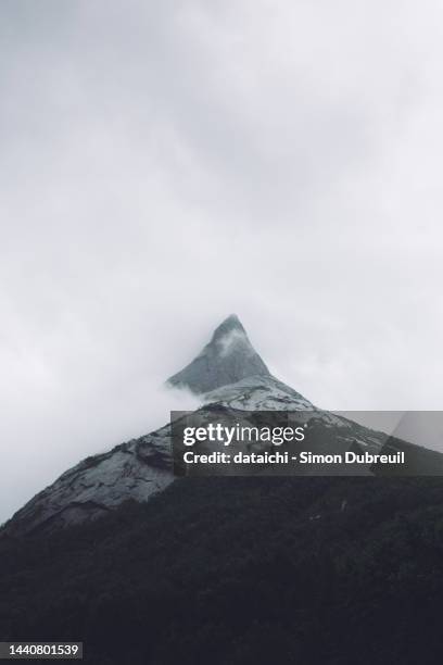 clouds around stetind mountain peak - stetind stock pictures, royalty-free photos & images