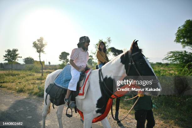 serene tourist mother and daughter riding a horse - indian family vacation stock pictures, royalty-free photos & images