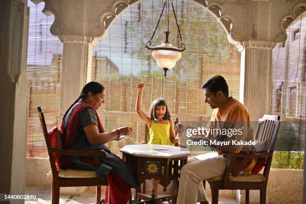 three generation family playing cards - indian family vacation stock pictures, royalty-free photos & images