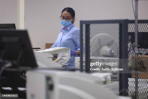 An election worker scans ballots at the Maricopa County Tabulation and Election Center on November 11, 2022 in Phoenix, Arizona. Ballots continue to...