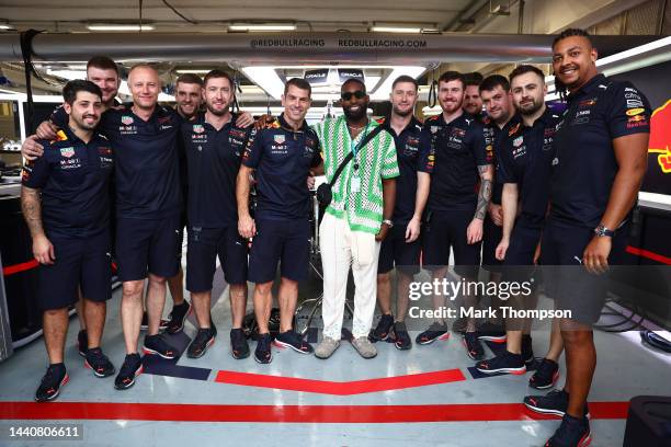 Tinie Tempah poses for a photo with the Red Bull Racing team in the Red Bull Racing garage prior to qualifying ahead of the F1 Grand Prix of Brazil...