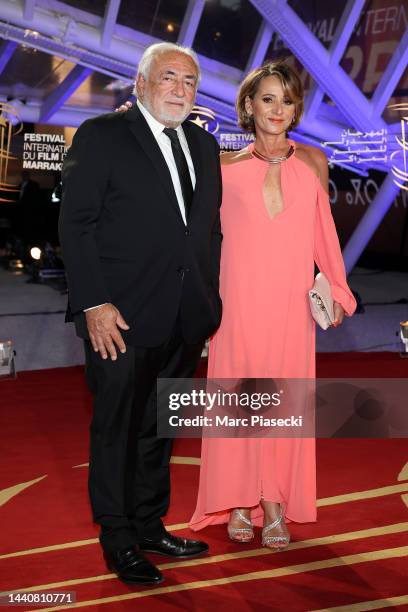 Dominique Strauss-Kahn and his wife Myriam L'Aouffir attend the opening ceremony during the 19th Marrakech International Film Festival on November...