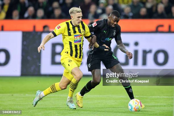 Nico Schlotterbeck of Borussia Dortmund battles for possession with Marcus Thuram of Borussia Monchengladbach during the Bundesliga match between...
