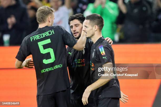 Jonas Hofmann of Borussia Monchengladbach celebrates with teammates after scoring their side's first goal during the Bundesliga match between...