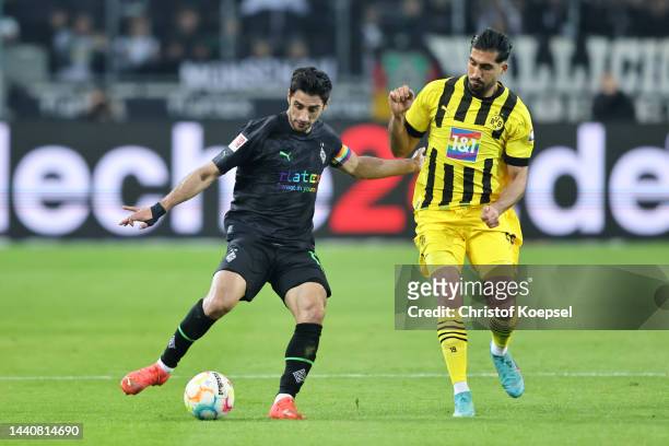 Lars Stindl of Borussia Monchengladbach battles for possession with Emre Can of Borussia Dortmund during the Bundesliga match between Borussia...
