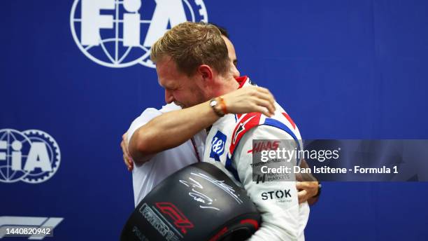 Pole position qualifier Kevin Magnussen of Denmark and Haas F1 is presented with the Pirelli Pole Position trophy by Felipe Massa during qualifying...