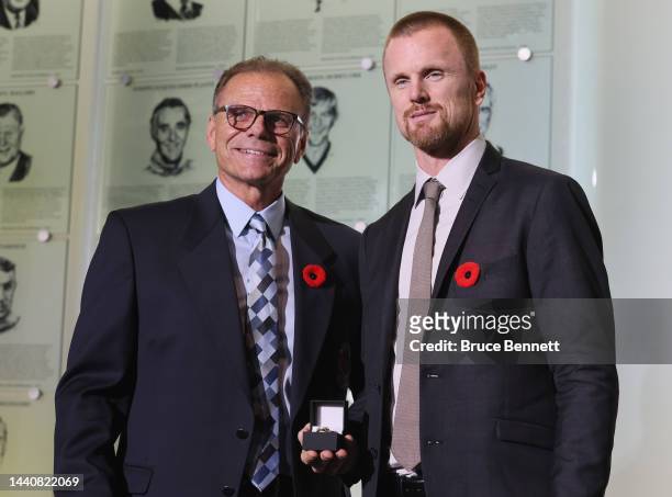 Chairman of the selection committee Mike Gartner presents the Hall ring to Daniel Sedin at a press opportunity at the Hockey Hall Of Fame on November...