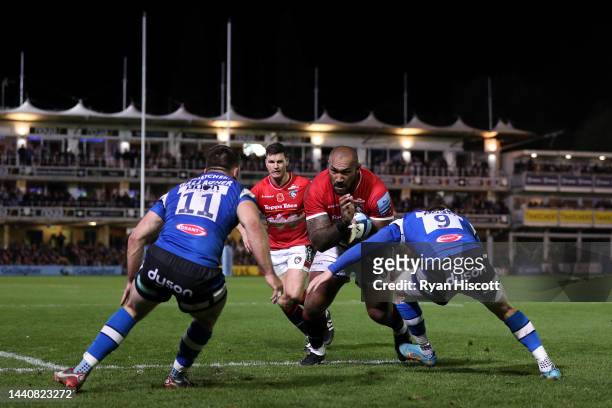 Nemani Nadolo of Leicester Tigers is challenged by Matt Gallagher and Ben Spencer of Bath Rugby during the Gallagher Premiership Rugby match between...