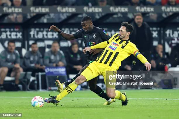 Mats Hummels of Borussia Dortmund battles for possession with Marcus Thuram of Borussia Monchengladbach during the Bundesliga match between Borussia...