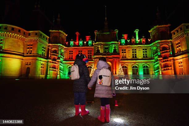 Twins Maya and Ruby watch a festive light show as Waddesdon Manor launches its Christmas Fair and Winter Light trail, on November 11, 2022 in...
