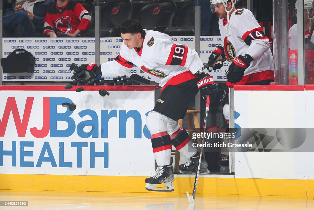 Batherson Drake Batherson of the Ottawa Senators knocks the pucks off the ledge ...