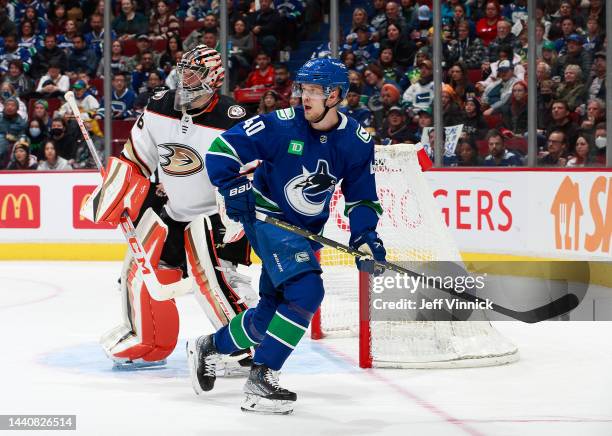 Elias Pettersson of the Vancouver Canucks skates by John Gibson of the Anaheim Ducks during their NHL game at Rogers Arena November 3, 2022 in...