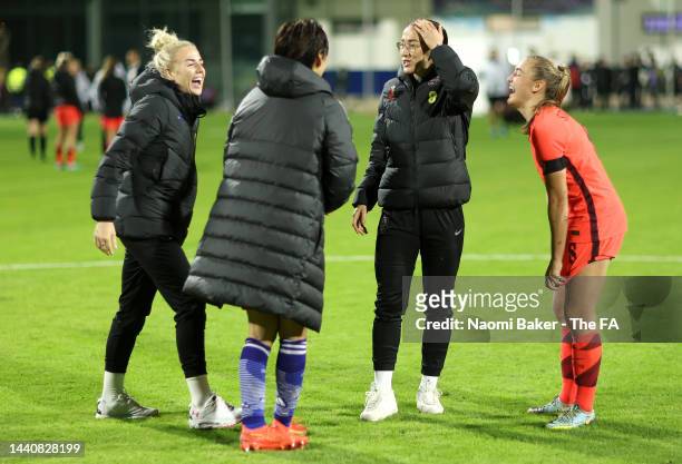Georgia Stanway, Alex Greenwood and Lucy Bronze of England talk to Saki Kumagai of Japan following the International Friendly between England and...