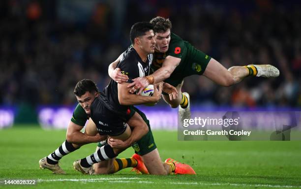 Dylan Brown of New Zealand is tackled by Nathan Cleary and Liam Martin of Australia during the Rugby League World Cup Semi-Final match between...