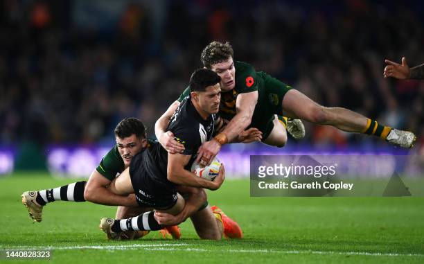 Dylan Brown of New Zealand is tackled by Nathan Cleary and Liam Martin of Australia during the Rugby League World Cup Semi-Final match between...