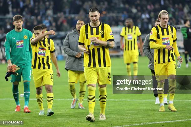 Gregor Kobel, Raphael Guerreiro, Niklas Sule and Julian Brandt of Borussia Dortmund look dejected following their side's defeat in the Bundesliga...