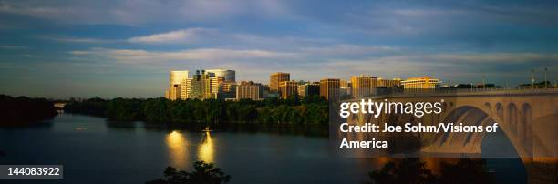 This shows sunrise over the Key Bridge on the Potomac River, The skyline of Rosslyn, Virginia is in the background.