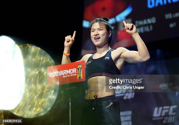 Zhang Weili of China poses on the scale during the UFC 281 ceremonial weigh-in at Radio City Music Hall on November 11, 2022 in New York City.