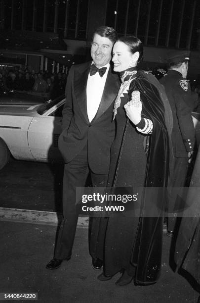 Outtake; Gloria Vanderbilt wearing a caped slinky black and white Adolfo with husband Wyatt Emory Cooper arrive to the world premiere Bob Fosse's...
