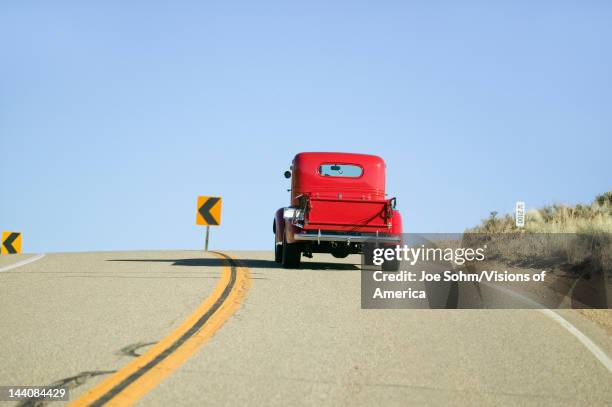 Restored bright Red Roadster hotrod pickup truck, mid-30's, drives rural highway in Kern County near Lockwood Valley, CA