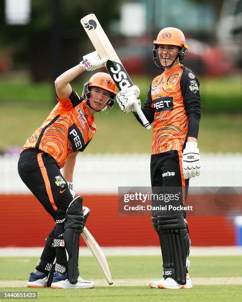 Beth Mooney of the Scorchers helps Marizanna Kapp of the Scorchers raise her bat after making a half century during the Women's Big Bash League match...
