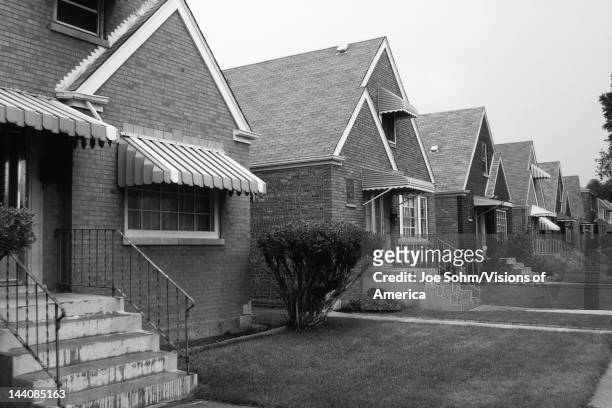 This is a black and white image of a row of single family houses, They are located on the south side of Chicago, They are brick houses with striped...