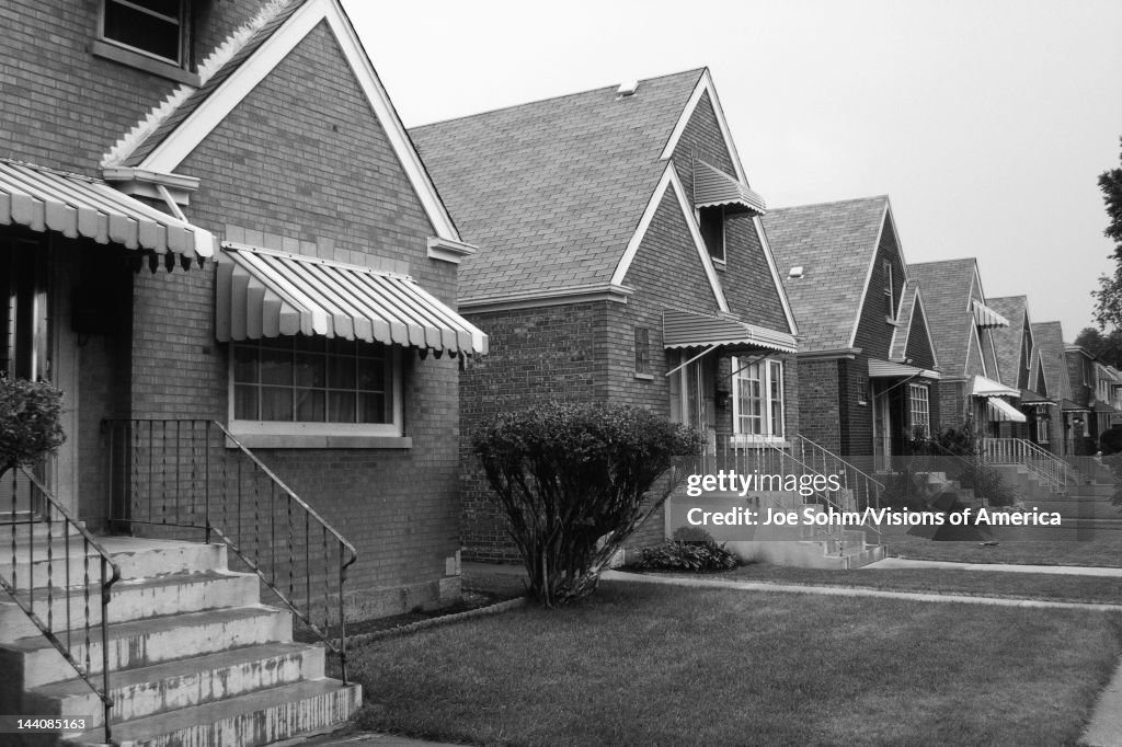 This is a black and white image of a row of single family houses.