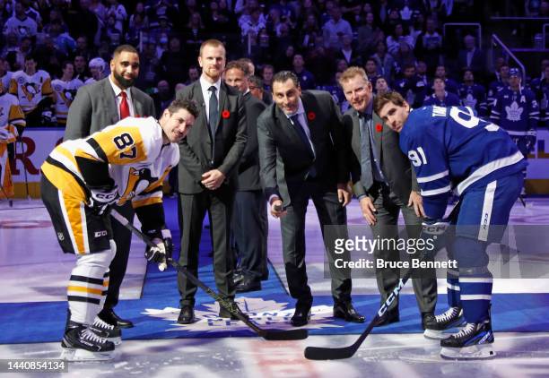 Daniel Sedin, Roberto Luongo and Daniel Alfredsson take part in a ceremony for their Hall of Fame induction prior to the game between the Toronto...