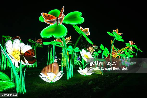 Luminous lanterns depicting butterfly insects on clover flowers, are displayed during the "Mini-Mondes En Voie D'Illumination - Mini Worlds On The...