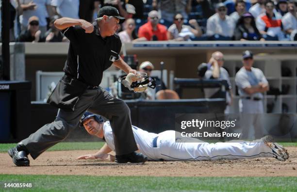 Home plate umpire Tom Hallion makes the call after Chase Headley of the San Diego Padres was tagged out while trying to score during the third inning...