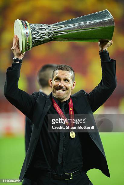 Atletico Madrid Coach Diego Simeone holds the trophy aloft at the end of the UEFA Europa League Final between Atletico Madrid and Athletic Bilbao at...