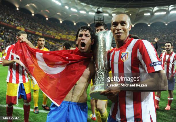 Arda Turan and Miranda of Atletico Madrid celebrate with the trophy at the end of the UEFA Europa League Final between Atletico Madrid and Athletic...