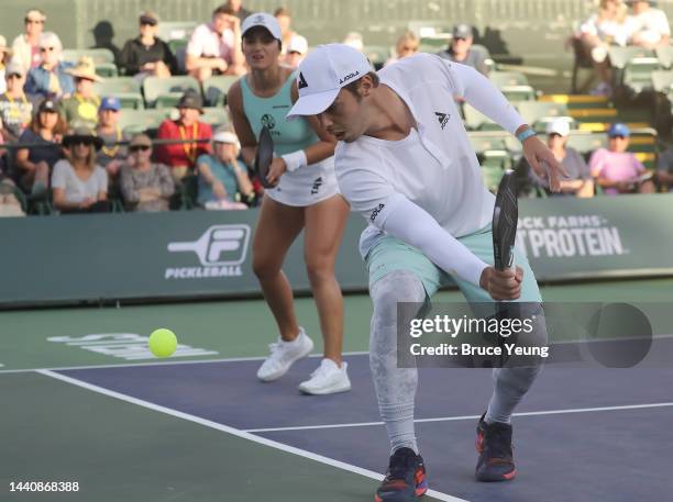 Ben Johns hits a backhand dink slice shot against JW Johnson and Parris Todd during the fourth round of the Pro Mixed Doubles division in the 2022...