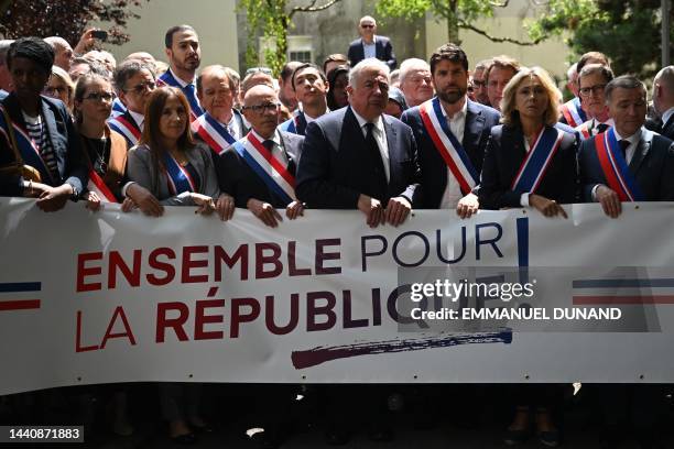 The Mayor of L'Hay-les-Roses Vincent Jeanbrun holds a banner reading "together for the republic" next to President of French ruling liberal party...