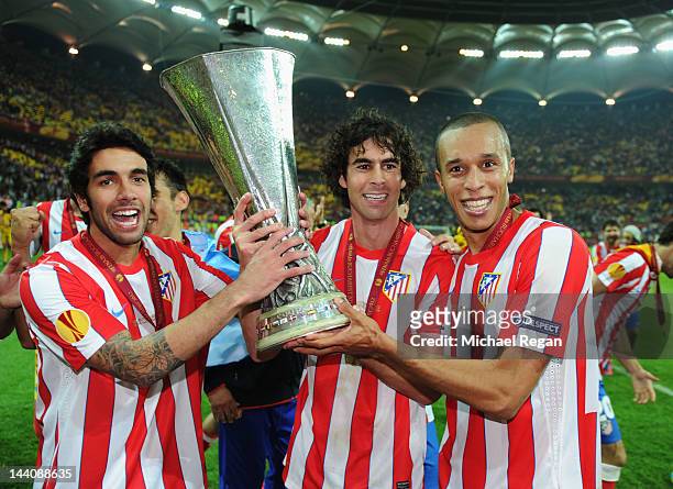 Silvio , Tiago and Miranda of Atletico Madrid celebrate with the trophy at the end of the UEFA Europa League Final between Atletico Madrid and...
