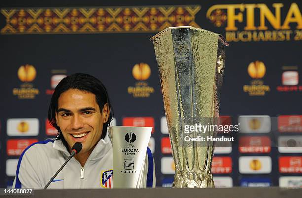 In this handout image provided by UEFA, Falcao of Atletico Madrid receives his Man of the Match award during the Atletico Madrid press conference...