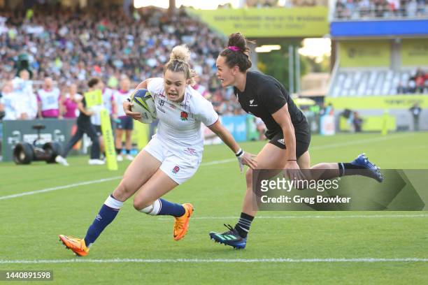 Ellie Kildunne of England scores a try against Portia Woodman of New Zealand during the Rugby World Cup 2021 Final match between England and New...