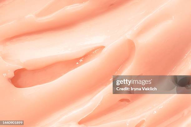 texture of delicate pink tea rose color smear of cosmetic product - pastel pink  color hair mask or facial cream,  hand cream, bb face cream. - hair mask stock pictures, royalty-free photos & images