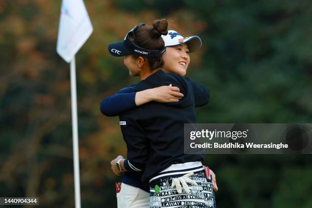 Miyu Shinkai of Japan is congratulated by Hikari Fujita after winning the tournament on the 18th green on the play off 8th hole during the final...